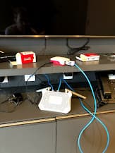 Raspberry Pis connected to a travel router in a hotel room for overnight flashing