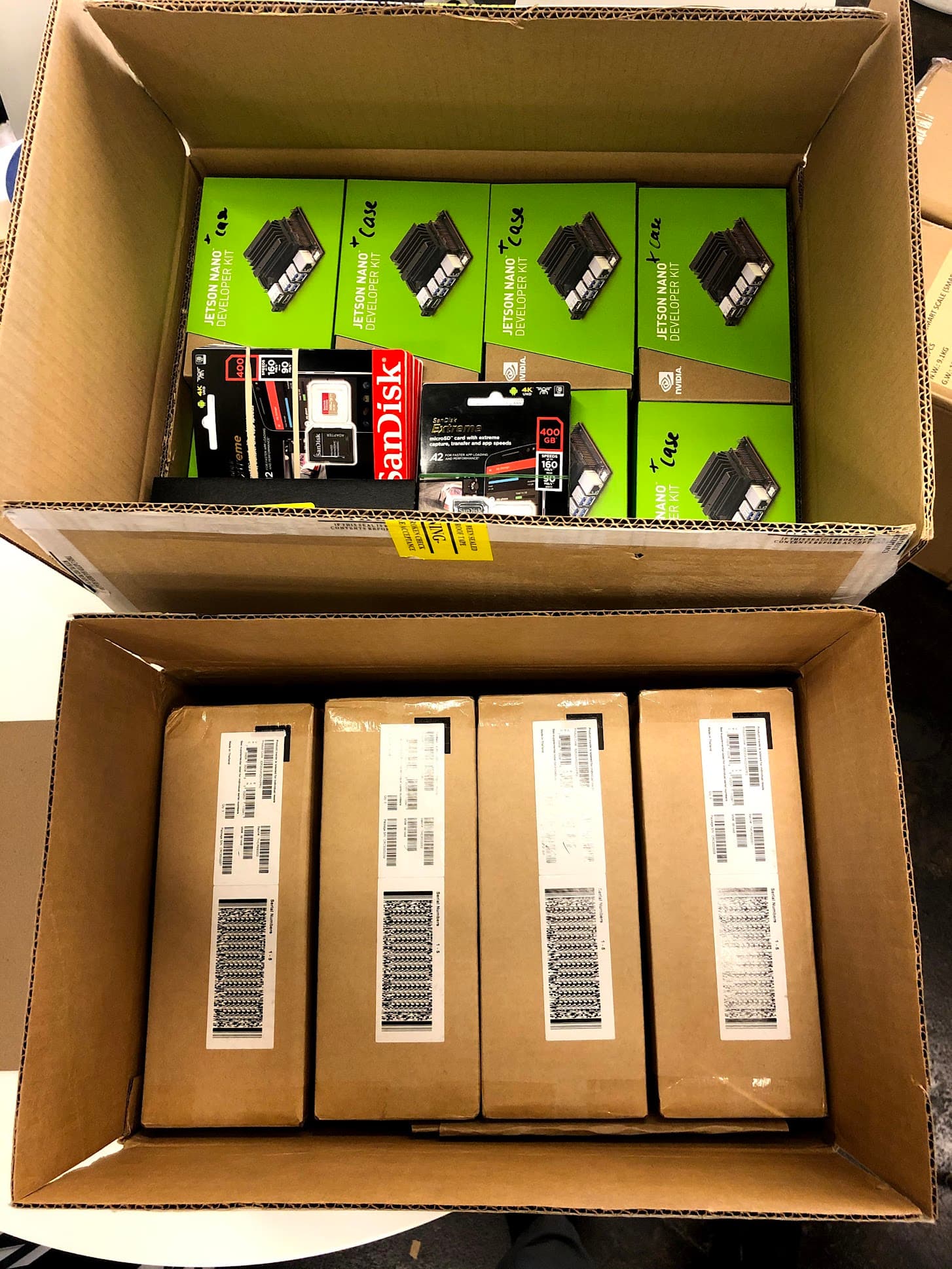 Boxes of NVIDIA Jetson Nano developer kits and SanDisk SD cards packed for shipment