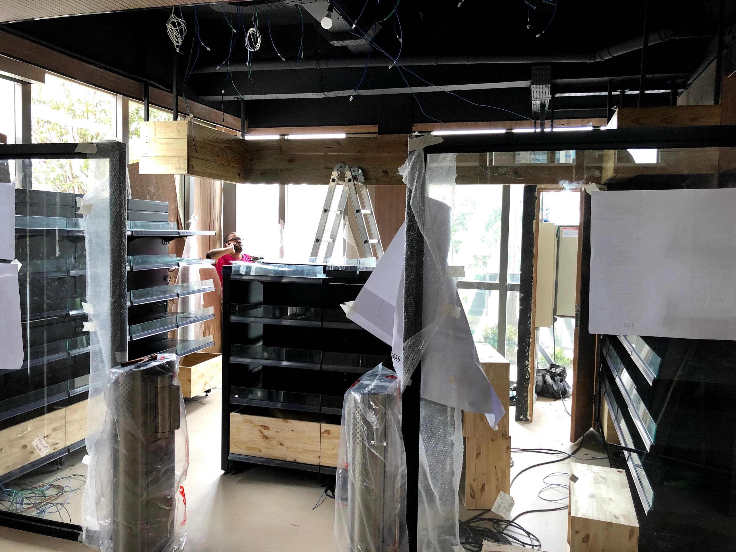Store under construction with shelving and camera mounts being installed